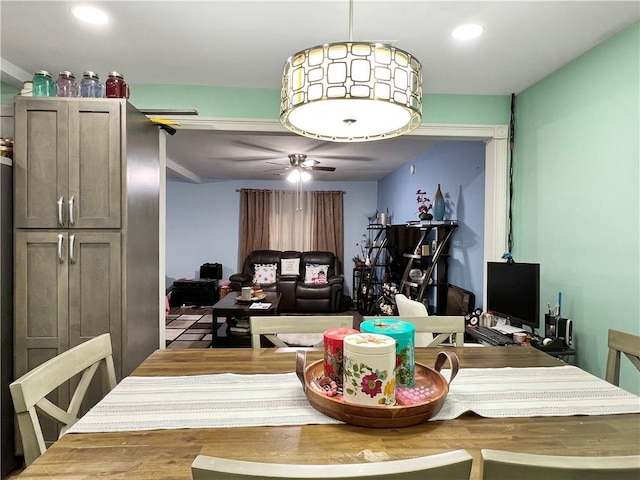 dining space with ceiling fan and hardwood / wood-style floors