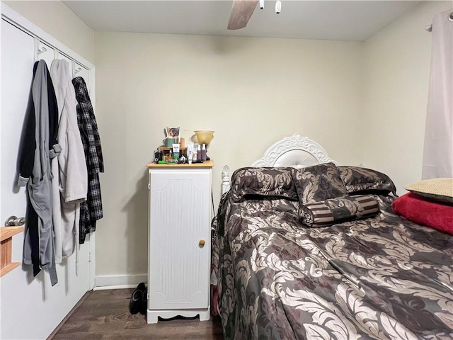 bedroom featuring a closet, ceiling fan, and dark wood-type flooring