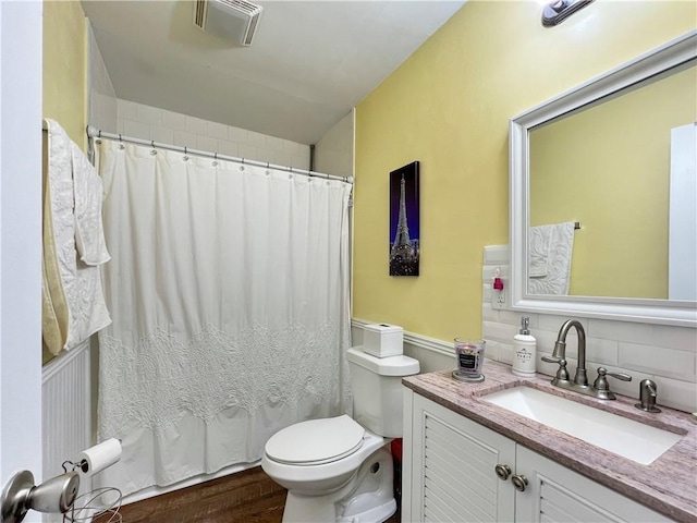 bathroom featuring walk in shower, tasteful backsplash, toilet, vanity, and hardwood / wood-style flooring