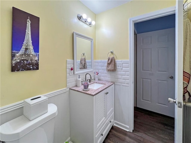 bathroom with hardwood / wood-style floors, vanity, and toilet