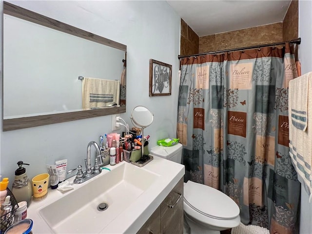 bathroom with vanity, toilet, and curtained shower