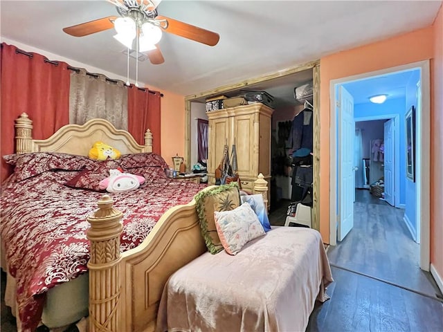 bedroom featuring hardwood / wood-style flooring, ceiling fan, and a closet