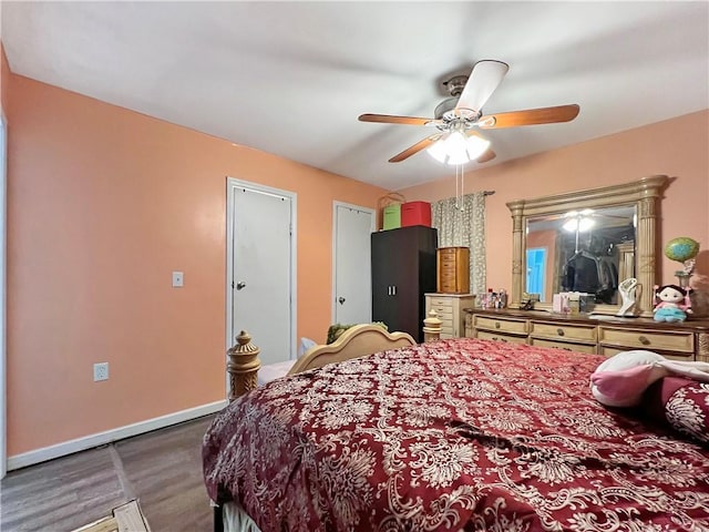 bedroom with ceiling fan and dark hardwood / wood-style flooring