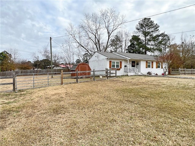 view of front facade with a storage shed and a front lawn