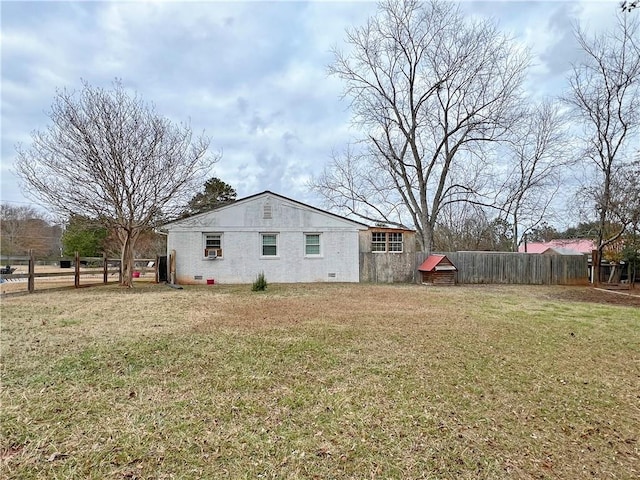 view of side of home featuring a yard