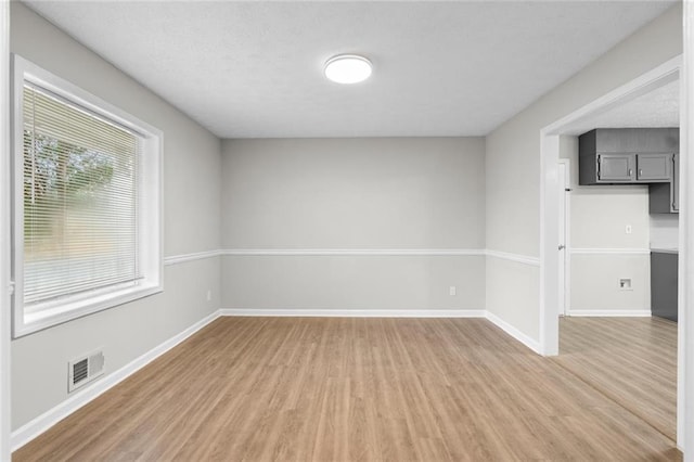 spare room with hardwood / wood-style floors