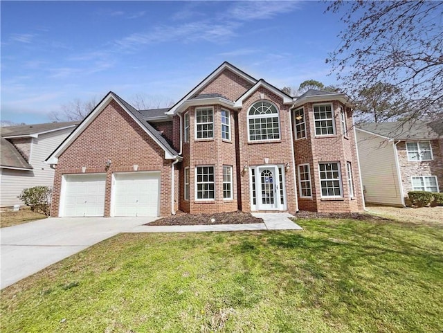 view of front of property with a garage, a front yard, brick siding, and driveway