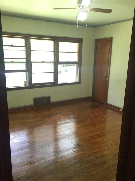 1410 Willis Mill Rd SW, Atlanta, GA 30311 - empty room with healthy amount of natural light, wood-type flooring, and ceiling fan