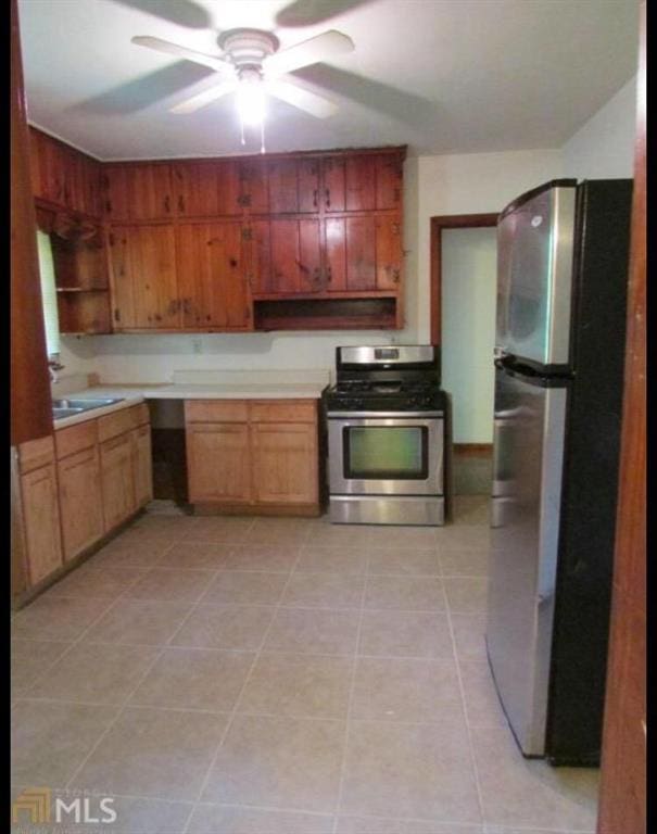 1410 Willis Mill Rd SW, Atlanta, GA 30311 - kitchen featuring appliances with stainless steel finishes, light countertops, light tile patterned flooring, ceiling fan, and open shelves