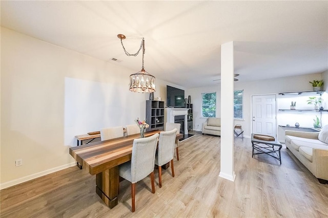 dining area featuring light hardwood / wood-style floors and a chandelier