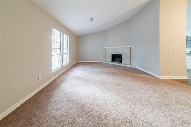 unfurnished living room with carpet flooring, lofted ceiling, and a fireplace