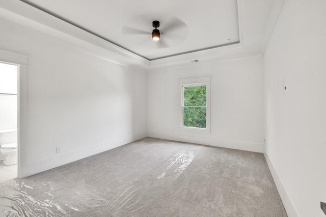 2335 Flat Stone Dr, Cumming, GA 30041 - carpeted spare room with a tray ceiling, baseboards, and a ceiling fan