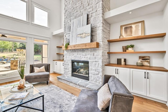 2335 Flat Stone Dr, Cumming, GA 30041 - living room with light wood-type flooring, a high ceiling, and a stone fireplace