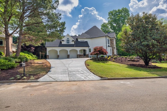 2335 Flat Stone Dr, Cumming, GA 30041 - french country inspired facade with an attached garage, stone siding, concrete driveway, stucco siding, and a front yard