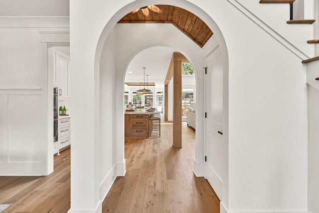 2335 Flat Stone Dr, Cumming, GA 30041 - hall featuring light wood-type flooring and arched walkways