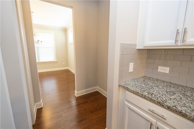 2034 W Hampton Dr, Canton, GA 30115 - hallway featuring crown molding, baseboards, an inviting chandelier, and dark wood finished floors