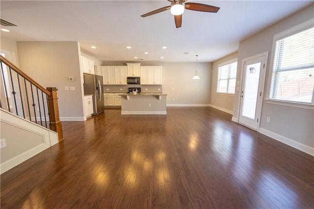 2034 W Hampton Dr, Canton, GA 30115 - unfurnished living room with dark wood-style flooring, ceiling fan, stairs, and recessed lighting