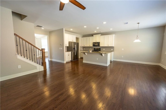 2034 W Hampton Dr, Canton, GA 30115 - kitchen featuring stainless steel fridge, a ceiling fan, a kitchen breakfast bar, dark wood-style floors, and black microwave