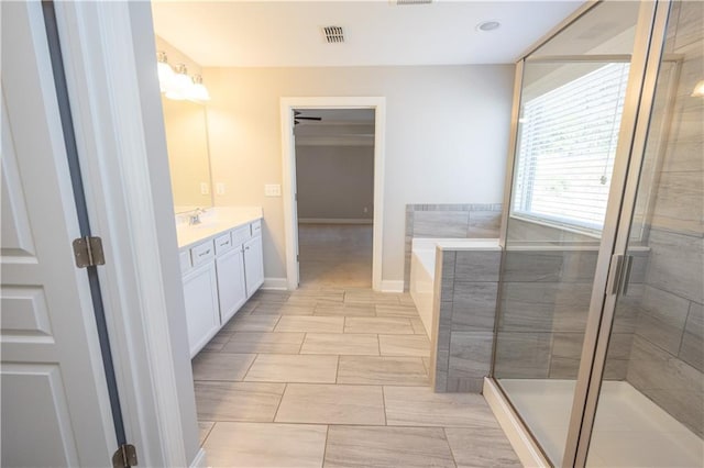 2034 W Hampton Dr, Canton, GA 30115 - bathroom featuring vanity, baseboards, a shower stall, visible vents, and a bath