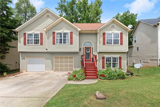 split foyer home with a garage, a front yard, and driveway