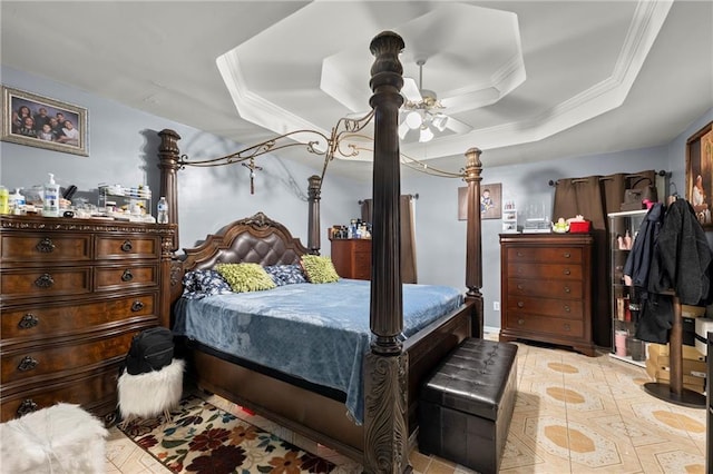 bedroom with a tray ceiling and crown molding