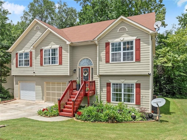 bi-level home featuring concrete driveway, a front lawn, and an attached garage