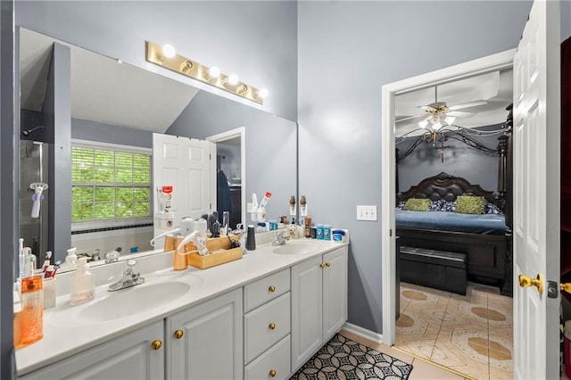 full bath with double vanity, tile patterned flooring, a sink, and connected bathroom