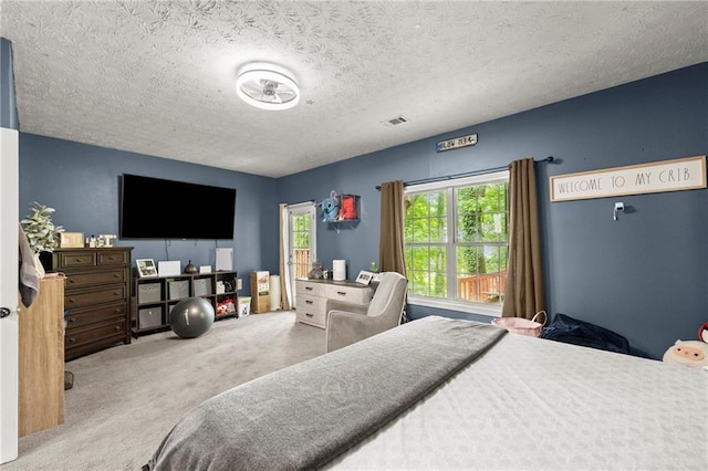 carpeted bedroom with a textured ceiling and visible vents