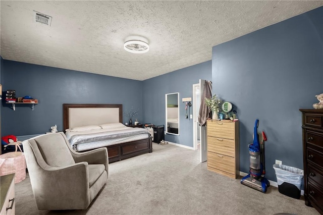 bedroom featuring visible vents, baseboards, a textured ceiling, and light colored carpet