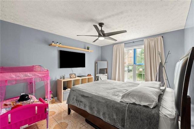 bedroom with a textured ceiling and ceiling fan