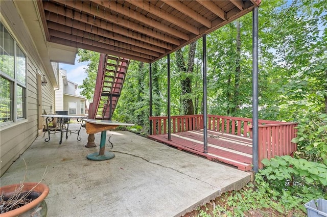 view of patio / terrace with outdoor dining space, stairs, and a wooden deck