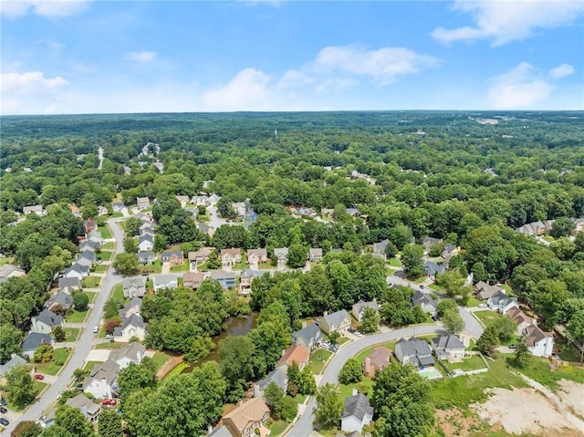 birds eye view of property featuring a residential view and a view of trees