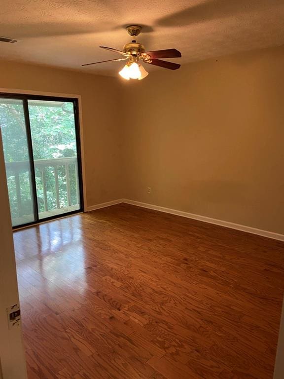 empty room with hardwood / wood-style flooring, a textured ceiling, and ceiling fan