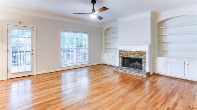 251 Waterford Cove Dr, Suwanee, GA 30024 - unfurnished living room with plenty of natural light, light wood-style flooring, a ceiling fan, ornamental molding, and a fireplace