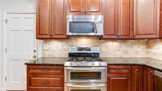 251 Waterford Cove Dr, Suwanee, GA 30024 - kitchen with appliances with stainless steel finishes, dark stone countertops, and backsplash