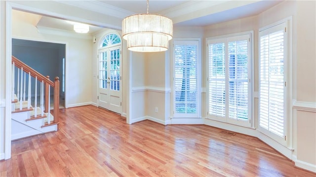 251 Waterford Cove Dr, Suwanee, GA 30024 - unfurnished dining area featuring wood finished floors, crown molding, stairs, and baseboards