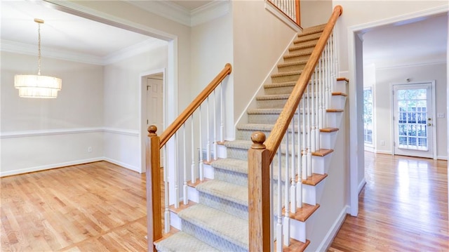 251 Waterford Cove Dr, Suwanee, GA 30024 - staircase featuring wood finished floors, crown molding, a chandelier, and baseboards