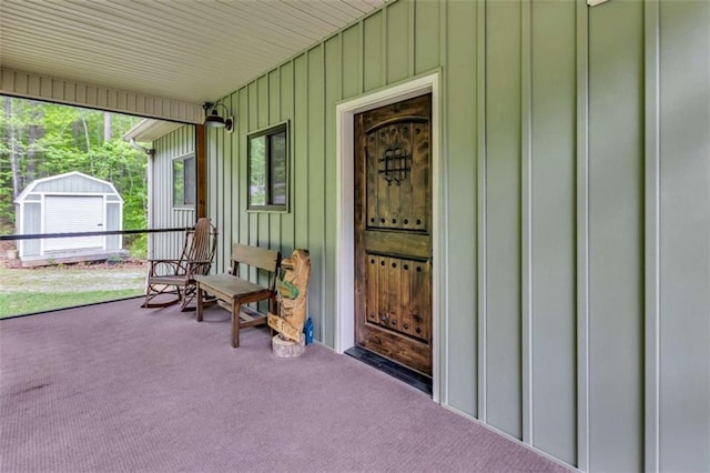 property entrance with board and batten siding and a porch