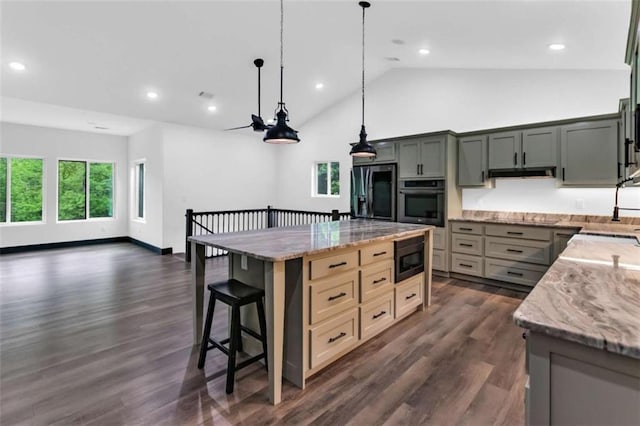 kitchen with oven, smart refrigerator, built in microwave, light stone countertops, and vaulted ceiling