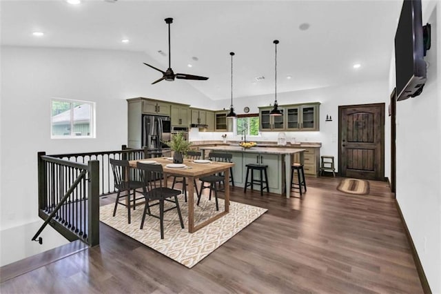 dining space featuring recessed lighting, dark wood-style flooring, baseboards, a ceiling fan, and high vaulted ceiling