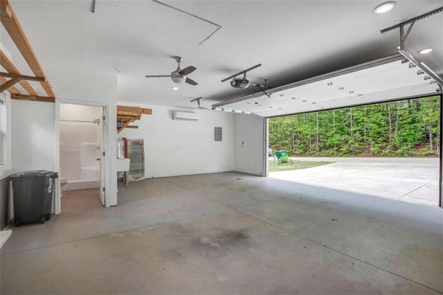 garage with a garage door opener, electric panel, and a ceiling fan