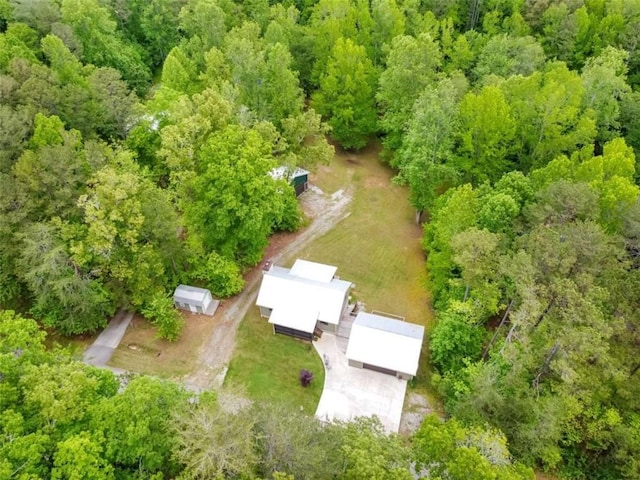 view of property location with a heavily wooded area