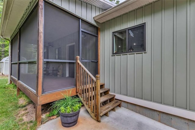 property entrance featuring board and batten siding
