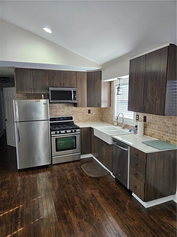 3268 Mae Ave, Brookhaven, GA 30319 - kitchen with light countertops, dark brown cabinets, stainless steel appliances, and lofted ceiling