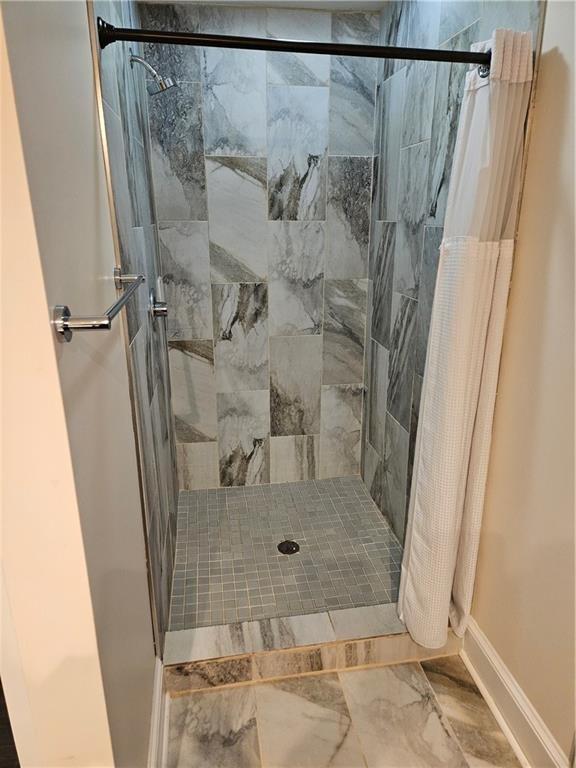 3268 Mae Ave, Brookhaven, GA 30319 - full bathroom with baseboards, marble finish floor, and a stall shower