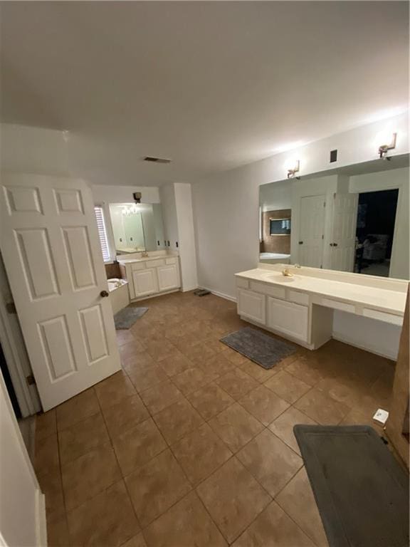 full bath featuring visible vents, a washtub, vanity, and tile patterned floors