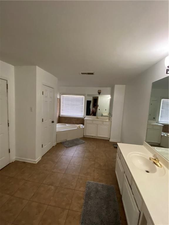 full bath featuring visible vents, vanity, a bath, and tile patterned floors