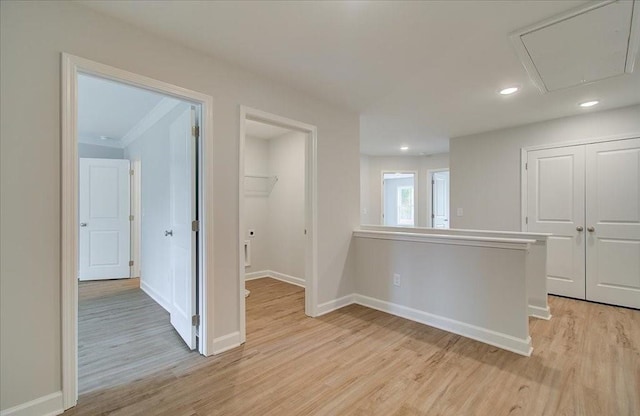 spare room with ornamental molding and light wood-type flooring