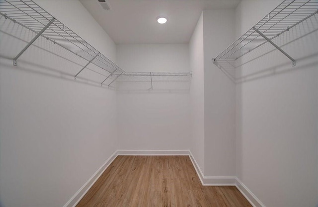 bathroom with vanity, a shower with shower door, wood-type flooring, and toilet