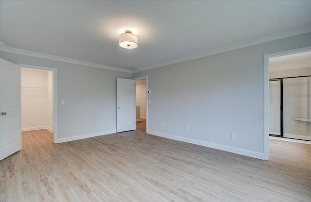 bathroom with a shower with door, wood-type flooring, and plenty of natural light